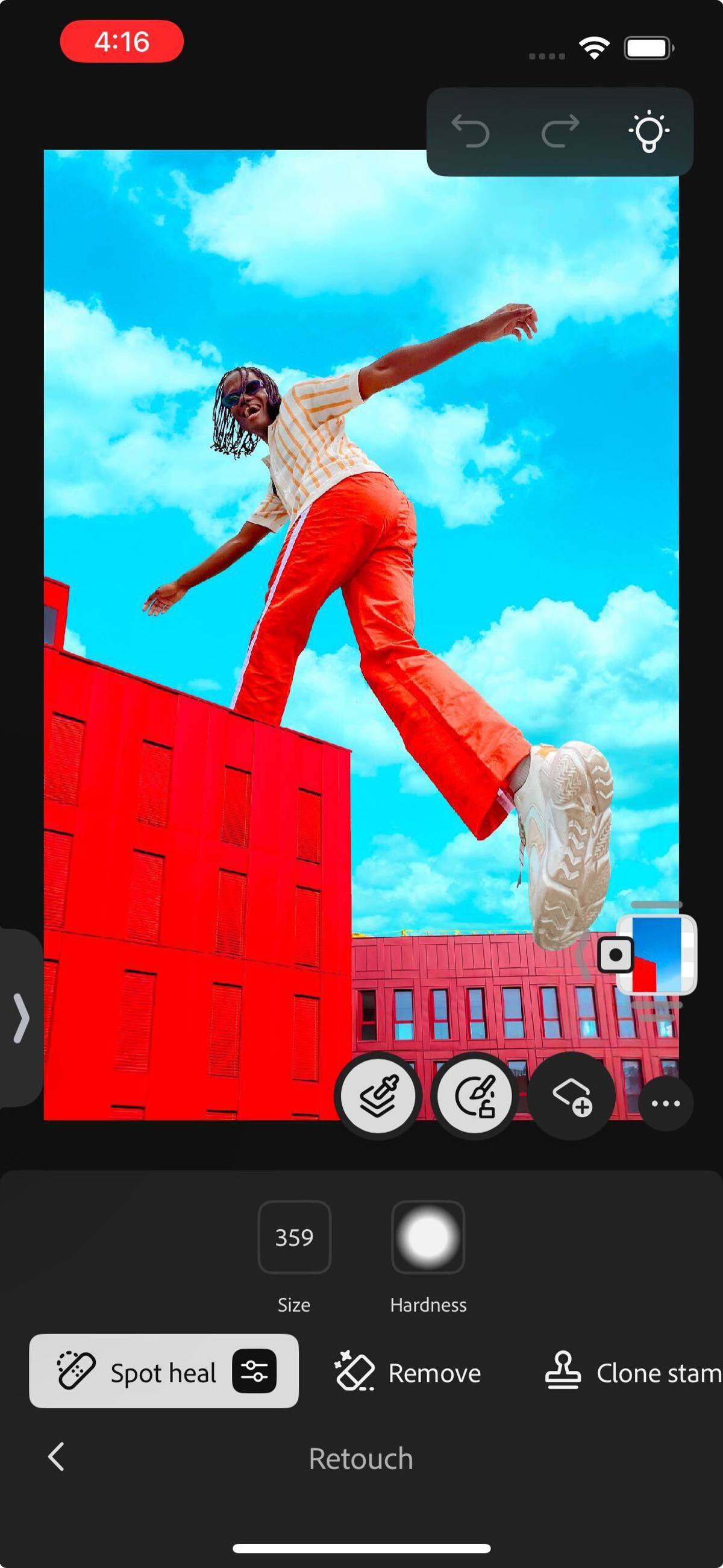 Retouch panel is opened, showcasing options to remove spots, lighten, darken and more.