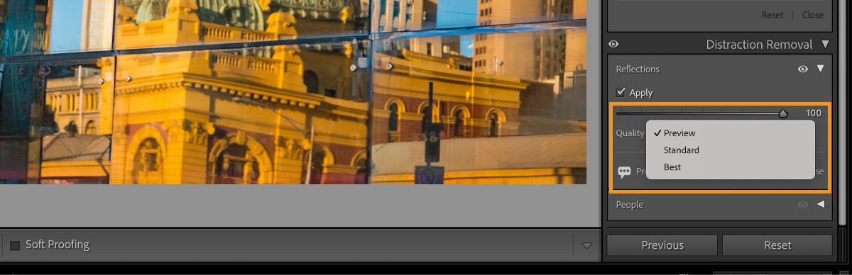 Screenshot of a photo editing software interface displaying a cityscape reflected in glass windows. The reflection shows yellow and orange buildings with columns and arches. A 'Distraction Removal' panel on the right has 'Reflections' checked, with quality set to 100, and options for 'Preview,' 'Standard,' and 'Best.' Buttons labeled 'Previous' and 'Reset' are below the panel.