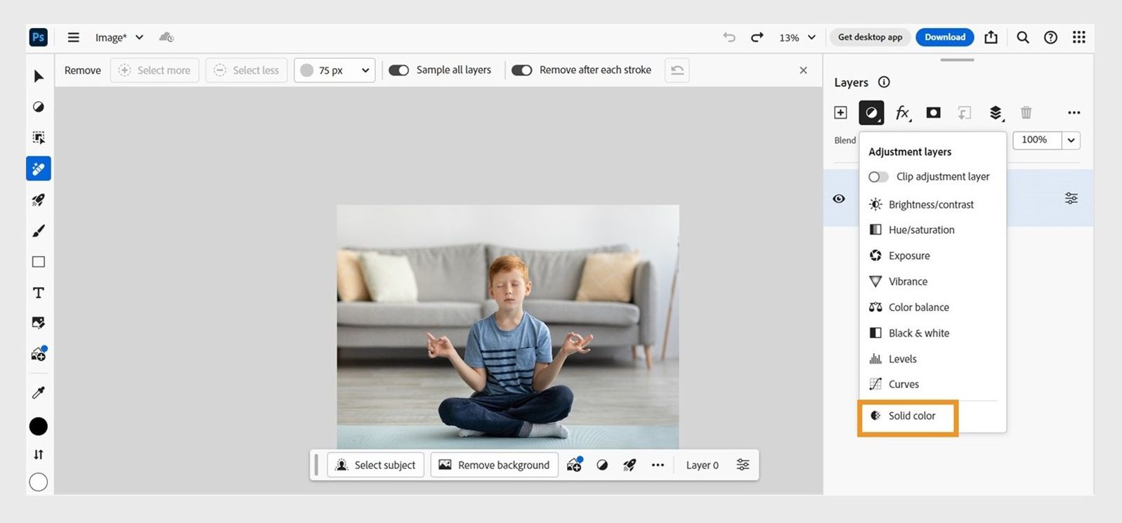 Photoshop on web home screen is shown with an image open on the canvas. Cursor is placed on the Solid color option available under the Adjustment menu drop-down list within the Layers panel. 