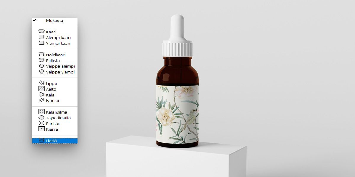 Photoshopin avattava Käyristys-valikko, jossa Lieriö-vaihtoehto on valittuna. Kuvassa näkyy pipettipullo, johon on kiinnitetty kukallinen etiketti. Pullo ja pipetti.